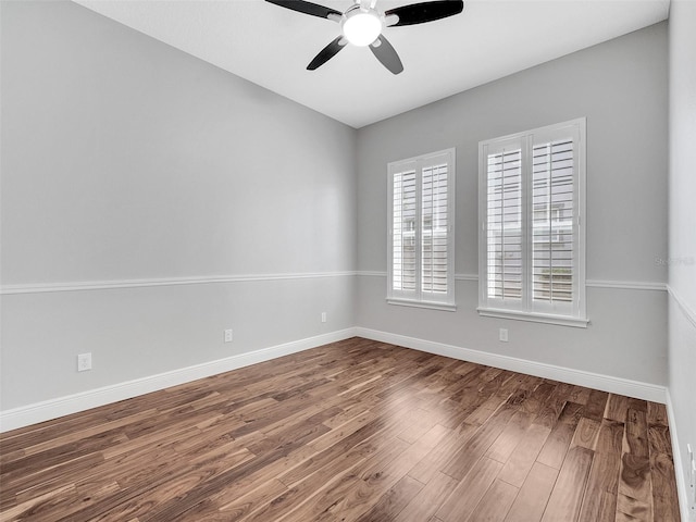 unfurnished room featuring baseboards, ceiling fan, and wood finished floors