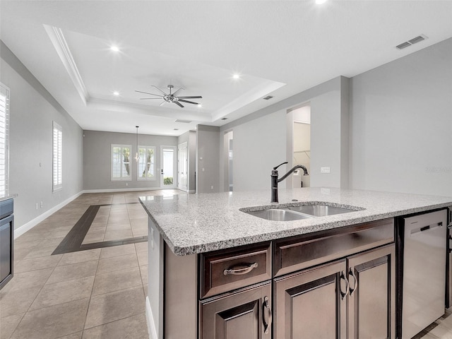 kitchen with stainless steel dishwasher, a ceiling fan, visible vents, a raised ceiling, and a sink