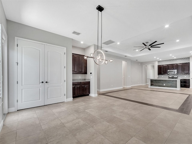 unfurnished living room with baseboards, recessed lighting, ceiling fan, and visible vents