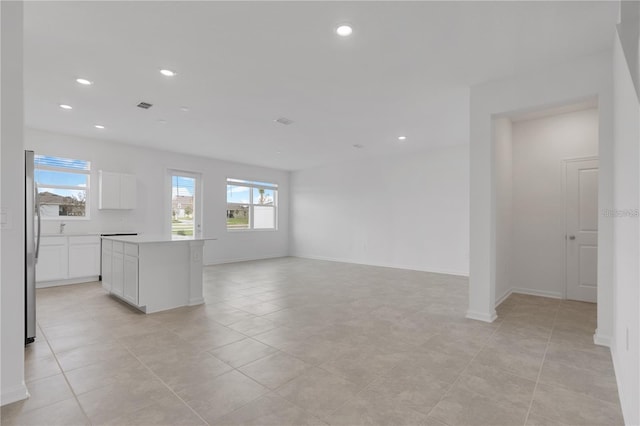 interior space with light tile patterned floors, baseboards, recessed lighting, and visible vents
