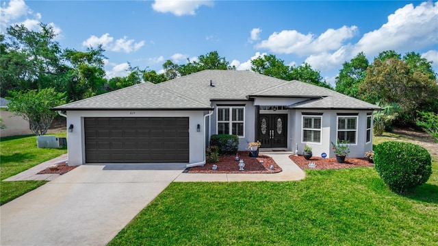 prairie-style home featuring an attached garage, a front lawn, stucco siding, and driveway