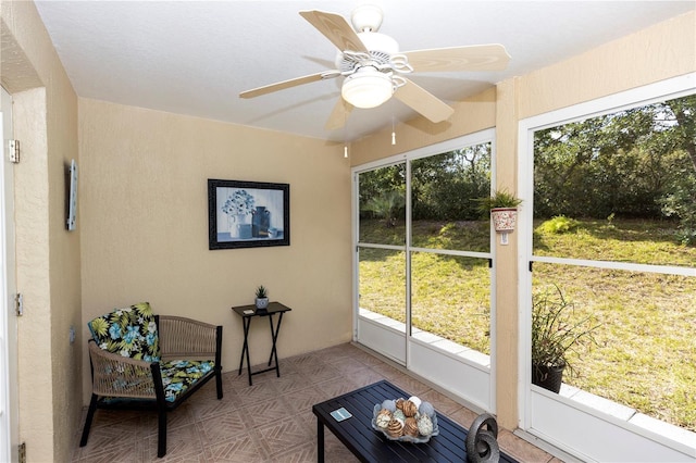 sunroom featuring a ceiling fan