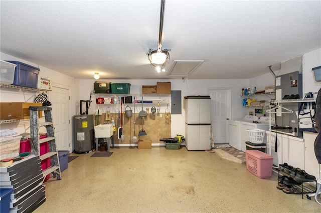 garage with water heater, separate washer and dryer, electric panel, and a sink