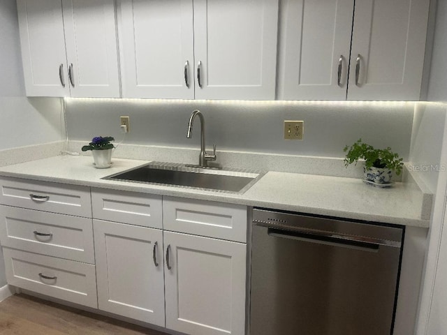 bar with stainless steel dishwasher, a sink, and wood finished floors