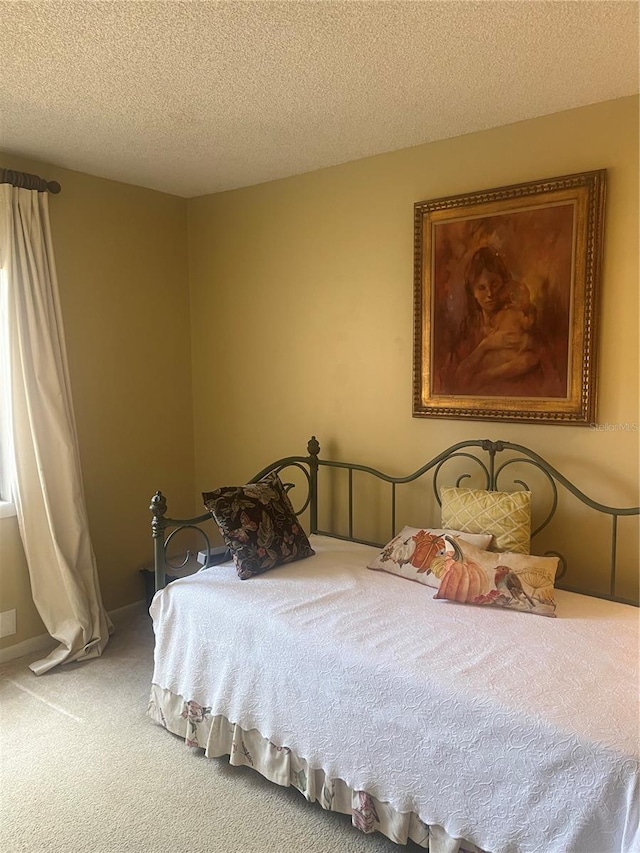 carpeted bedroom with a textured ceiling