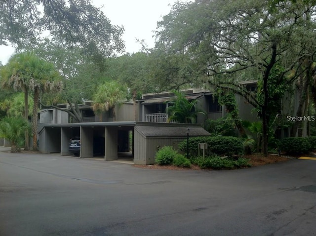 townhome / multi-family property featuring covered parking