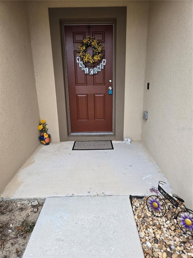 119 Stewart Lake Loop, Groveland, FL 34736 - doorway to property featuring stucco siding