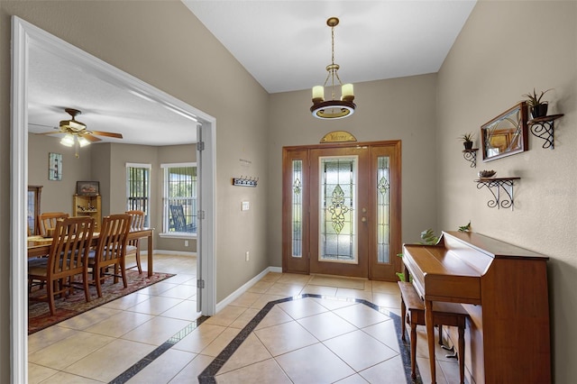entrance foyer with light tile patterned flooring, baseboards, and ceiling fan with notable chandelier