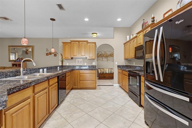 kitchen featuring light tile patterned flooring, a sink, visible vents, pendant lighting, and black appliances