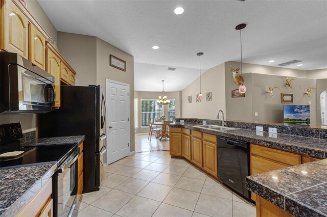kitchen with pendant lighting, a sink, black appliances, tile counters, and light tile patterned flooring