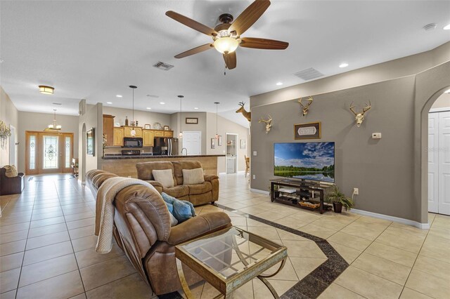 living room featuring arched walkways, a ceiling fan, recessed lighting, and visible vents