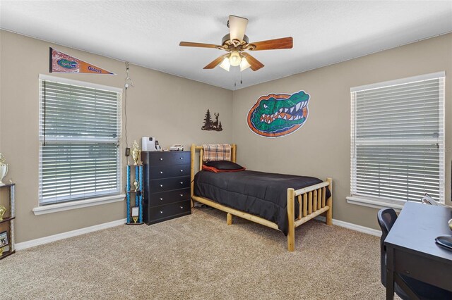 bedroom with baseboards, carpet, and a ceiling fan