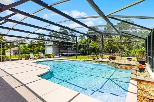 outdoor pool with a patio and a lanai