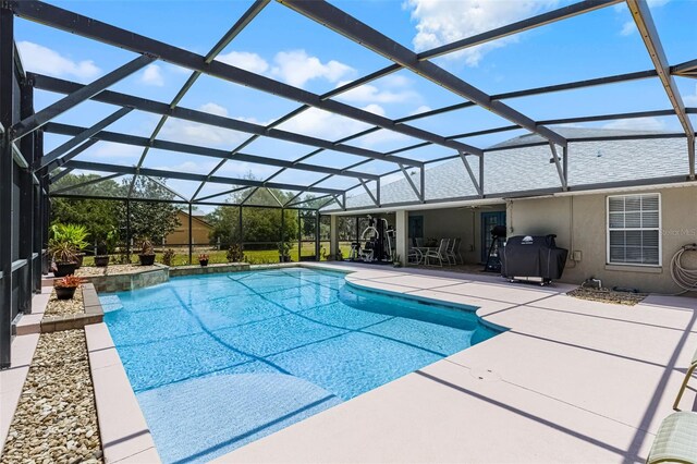 outdoor pool featuring grilling area, a lanai, and a patio area