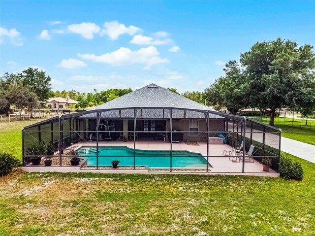 view of swimming pool with a fenced in pool, a patio area, a lanai, and a yard