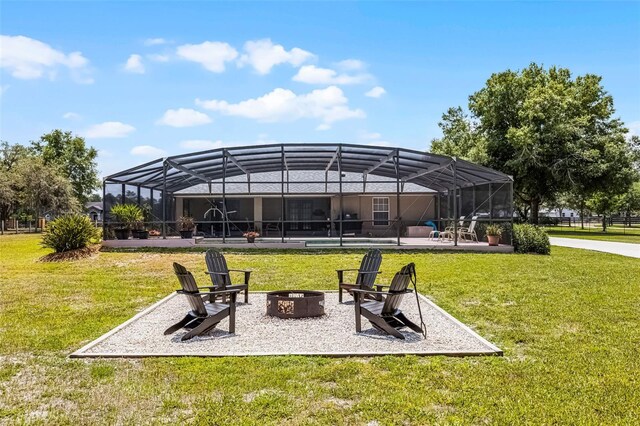 view of community featuring a yard, a fire pit, and a patio area