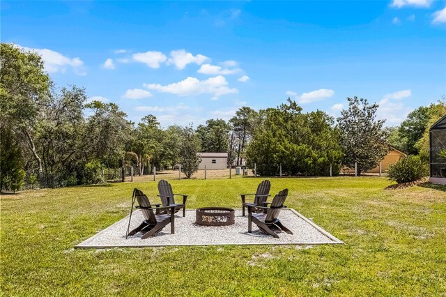 view of yard featuring a patio and an outdoor fire pit