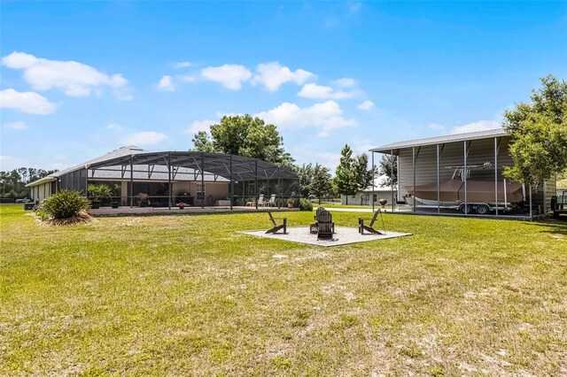 view of yard with a patio area, a fire pit, and a lanai