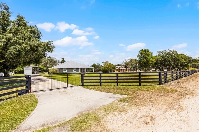 view of gate with a yard and fence