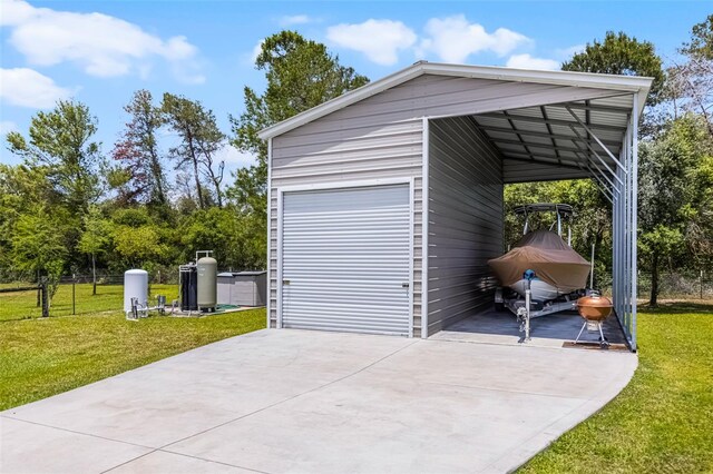 garage with fence and driveway