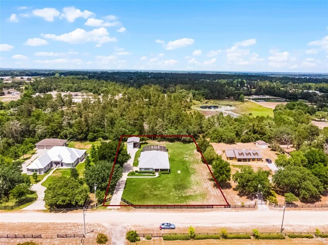 drone / aerial view featuring a wooded view
