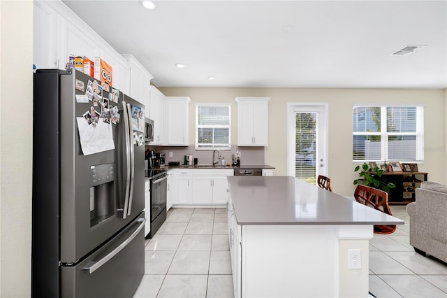 2919 Verse St, Kissimmee, FL 34746 - kitchen featuring visible vents, a sink, light tile patterned floors, and stainless steel appliances