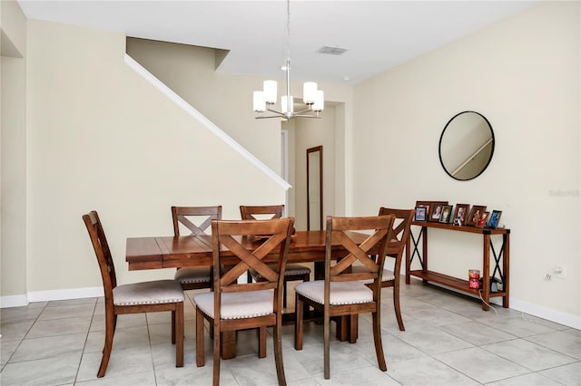 2919 Verse St, Kissimmee, FL 34746 - dining room with stairs, baseboards, a chandelier, and light tile patterned floors