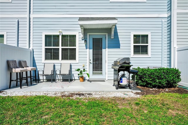 2919 Verse St, Kissimmee, FL 34746 - view of exterior entry with a lawn, a patio, and fence