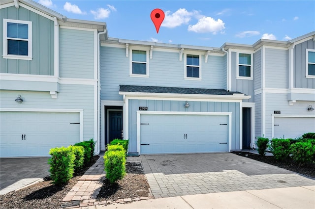 2919 Verse St, Kissimmee, FL 34746 - multi unit property with board and batten siding, decorative driveway, and an attached garage