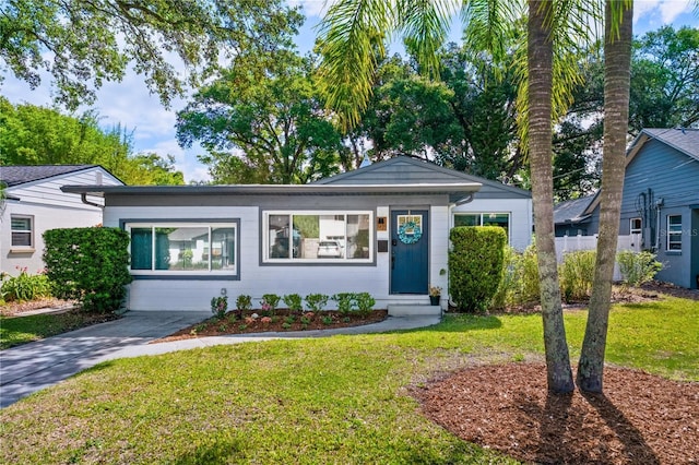 ranch-style house with a front yard and entry steps