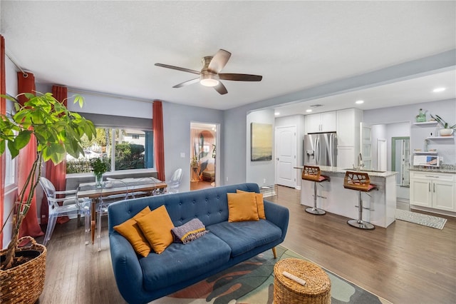 living area featuring recessed lighting, a ceiling fan, and dark wood-style floors