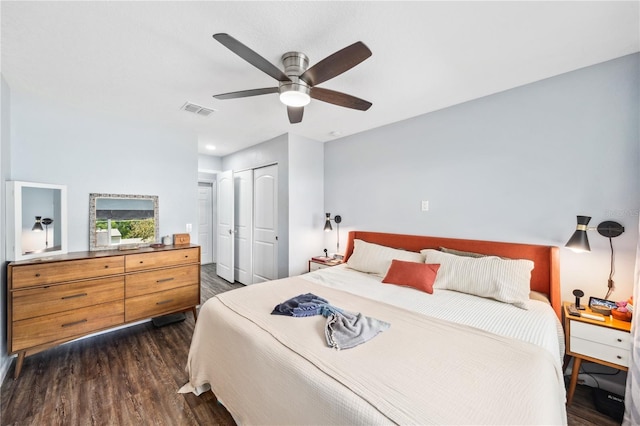 bedroom with visible vents, dark wood-type flooring, a closet, and ceiling fan