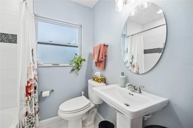 full bathroom with baseboards, a sink, and toilet