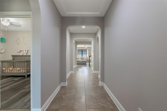 15443 Sugarcup Ct, Orlando, FL 32828 - hall featuring arched walkways, tile patterned floors, and baseboards