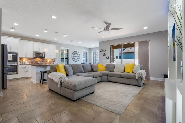 15443 Sugarcup Ct, Orlando, FL 32828 - living area with a ceiling fan, recessed lighting, and baseboards