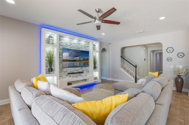 15443 Sugarcup Ct, Orlando, FL 32828 - tiled living area featuring arched walkways, ceiling fan, stairway, baseboards, and recessed lighting