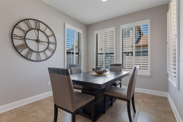 15443 Sugarcup Ct, Orlando, FL 32828 - dining room with baseboards and light tile patterned floors