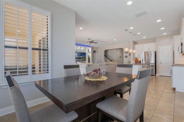 15443 Sugarcup Ct, Orlando, FL 32828 - dining space featuring light tile patterned floors, a ceiling fan, arched walkways, recessed lighting, and baseboards