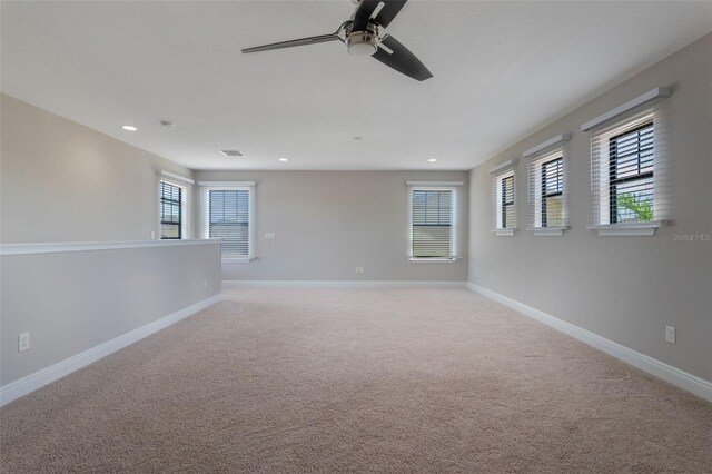 15443 Sugarcup Ct, Orlando, FL 32828 - unfurnished room with light colored carpet, baseboards, a ceiling fan, and recessed lighting