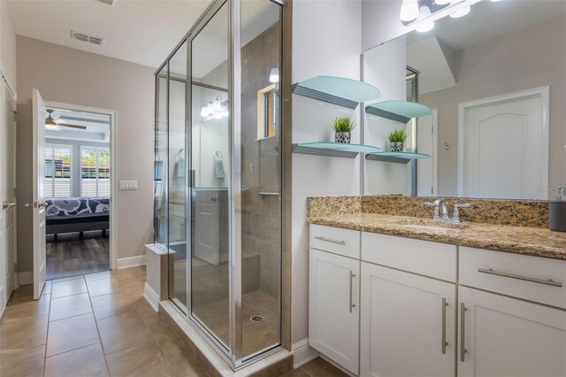 15443 Sugarcup Ct, Orlando, FL 32828 - ensuite bathroom featuring a shower stall, baseboards, vanity, tile patterned floors, and ceiling fan