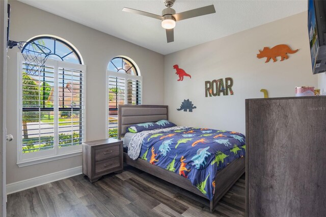 15443 Sugarcup Ct, Orlando, FL 32828 - bedroom featuring dark wood-style flooring, baseboards, and ceiling fan