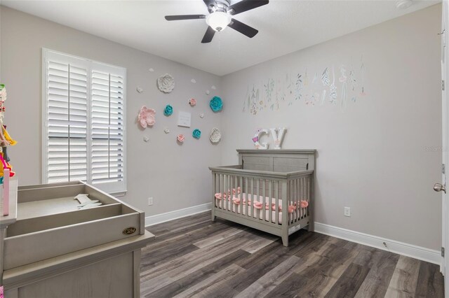 15443 Sugarcup Ct, Orlando, FL 32828 - bedroom featuring a nursery area, wood finished floors, baseboards, and ceiling fan