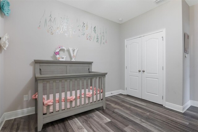 15443 Sugarcup Ct, Orlando, FL 32828 - bedroom with wood finished floors, baseboards, a closet, and a crib