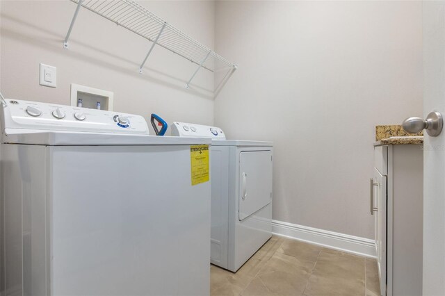 15443 Sugarcup Ct, Orlando, FL 32828 - washroom featuring washing machine and clothes dryer and baseboards