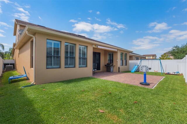 15443 Sugarcup Ct, Orlando, FL 32828 - back of house with a patio area, stucco siding, and central AC