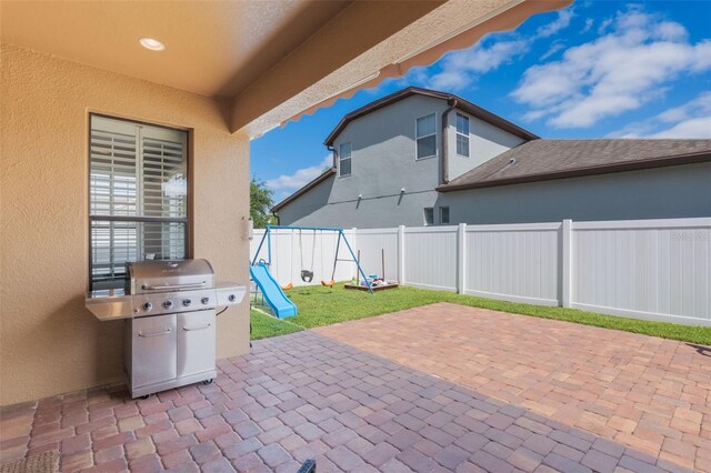 15443 Sugarcup Ct, Orlando, FL 32828 - view of patio / terrace featuring a playground and a grill