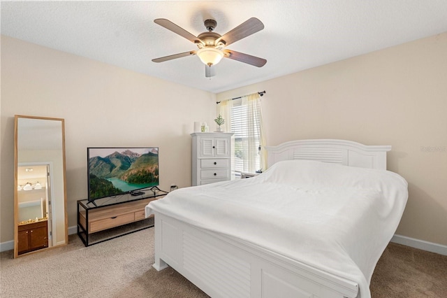 bedroom featuring light colored carpet, baseboards, and a ceiling fan