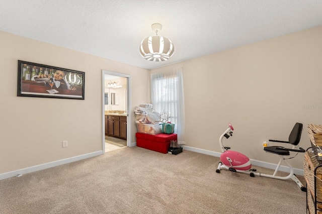 game room featuring light colored carpet, a chandelier, and baseboards