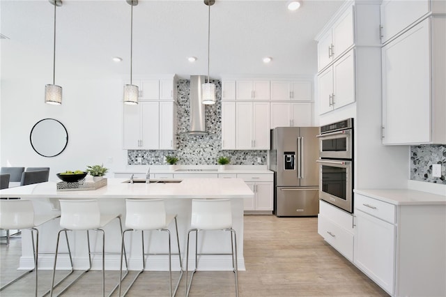 10139 Austrina Oak Loop, Winter Garden, FL 34787 - kitchen with decorative backsplash, appliances with stainless steel finishes, white cabinetry, a sink, and wall chimney exhaust hood