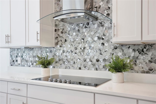 10139 Austrina Oak Loop, Winter Garden, FL 34787 - kitchen with light countertops, black electric cooktop, range hood, and tasteful backsplash